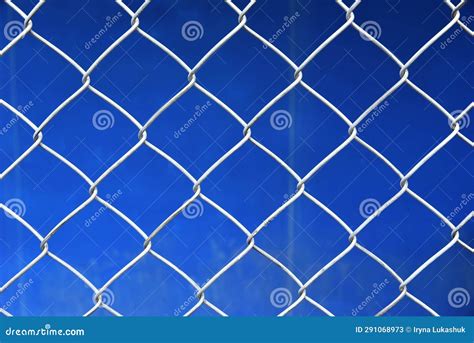Wire Grid Closeup Of Chain Link Fence On Blue Sky Background Stock