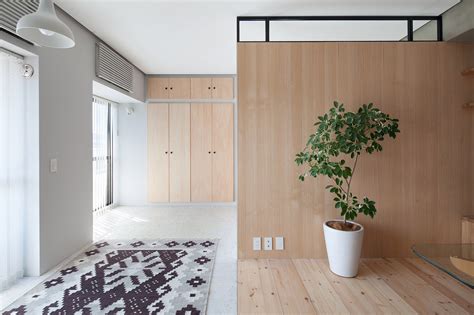 L Shaped Wood Partition Unifies All Areas In Small Practical Apartment