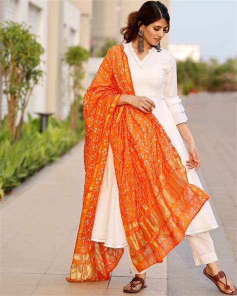 White Flared Kurta And Pants With Orange Bandhej Dupatta Set Of Three By Pheeta The Secret Label