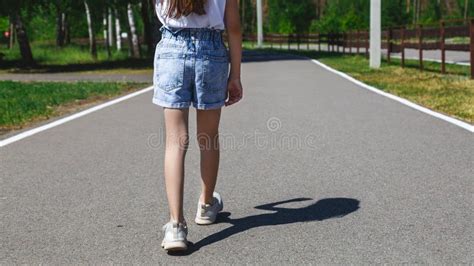 Close Up Of Child Legs Walking Away From Camera In The Road Stock Image