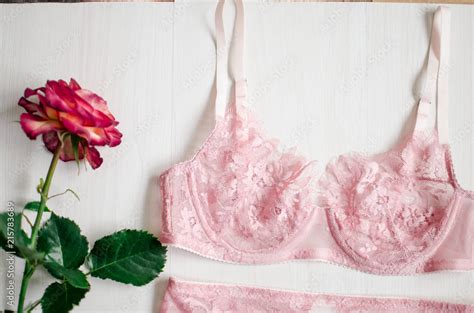 Sexy Pink Lingerie Set With Stocking Suspender Lace Underwear On The White Background With Rose