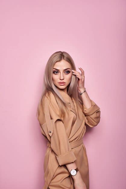 Premium Photo Sensual Blonde Beautiful Woman Posing In Studio On A Pink