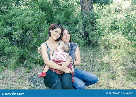 Adorable Lesbian Couple With Their Baby Girl In Nature Stock Image Image Of Homosexual