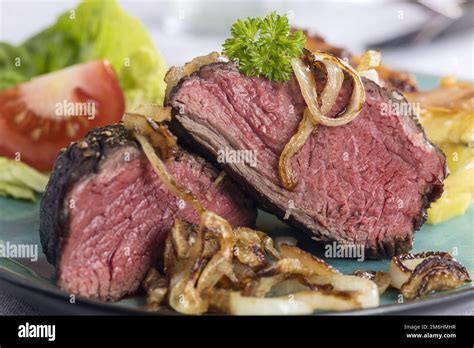 Sliced Steak With Onions Stock Photo Alamy