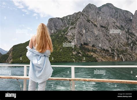 Blonde Woman Enjoying Mountain View On A Ferry Stock Photo Alamy