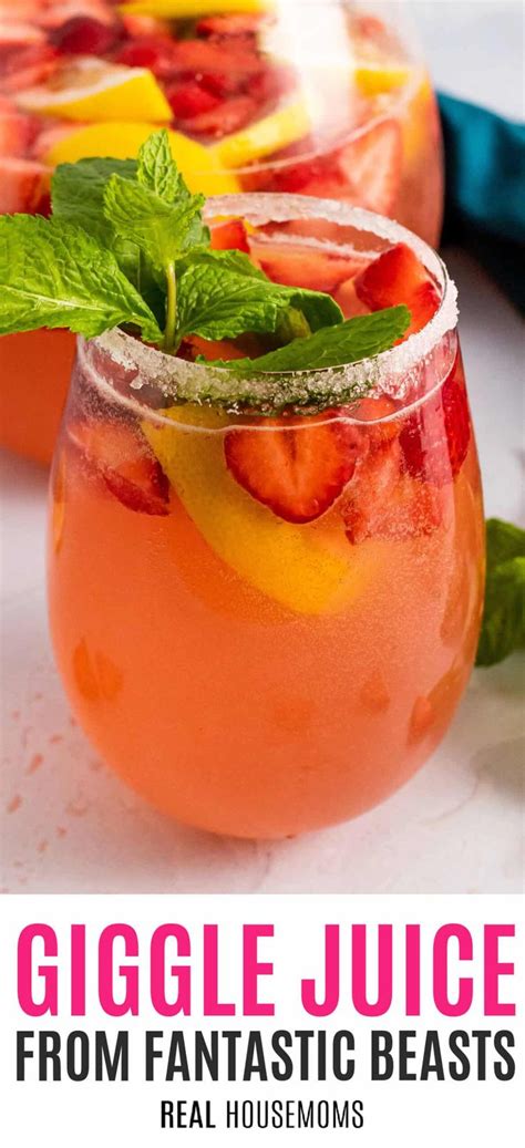 A Close Up Of A Drink In A Glass With Strawberries And Mint On The Rim