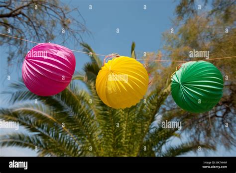 Outdoor party with lanterns and tropical trees Stock Photo - Alamy