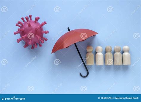 Community Or Public Health And Life Insurance Concept Wooden People Under A Red Umbrella Stock