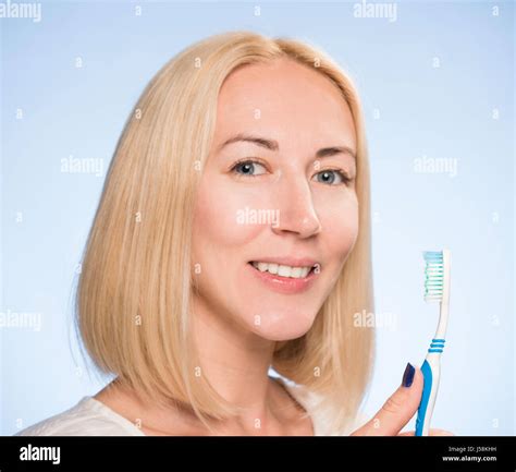 Beautiful Blonde Cleans Teeth Stock Photo Alamy
