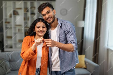 premium photo excited young indian husband  wife showing keys
