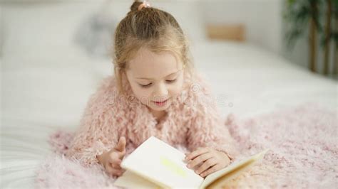 Adorable Blonde Girl Reading Book Lying On Bed At Bedroom Stock Footage Video Of Resting