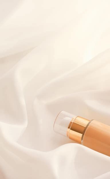 Premium Photo Tonal Bb Cream Bottle Makeup Fluid Foundation Base For Nude Skin Color On Silk