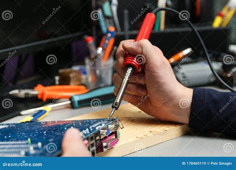 Worker`s Hands Solder With Soldering Iron In The Workshop Stock Image