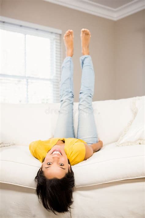 Smiling Brunette On Sofa With Legs Up Stock Photo Image Of Domicile Homey