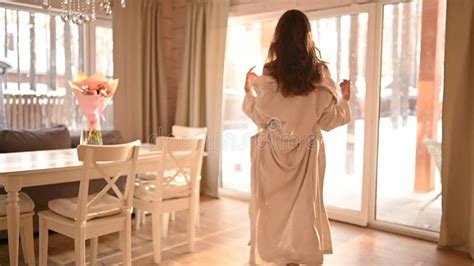 Beautiful Slim Naked Woman Long Hair Goes To Panoramic Windows Slowly Taking Off The White