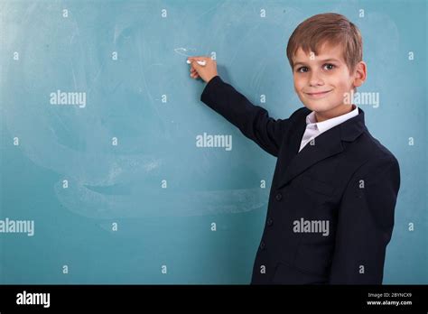 School student writing on blackboard at school Stock Photo - Alamy