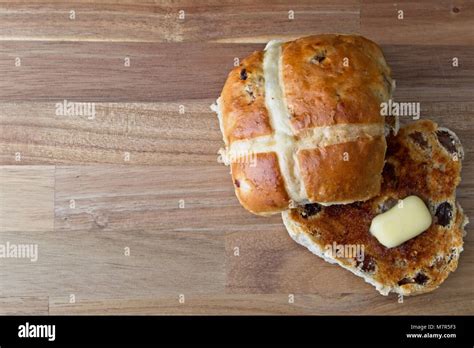Toasted Hot Cross Bun With Melting Butter On Wooden Surface Stock Photo Alamy