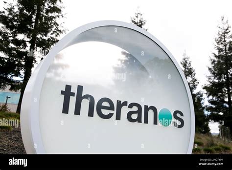 A logo sign outside of the headquarters of Theranos in Palo Alto ...