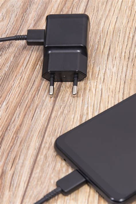 Black Smartphone And Charger Using To Charge Empty Battery Various