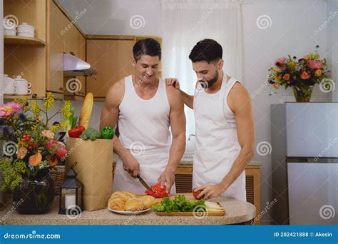 Caucasian Lgbtq Gay Couple Enjoying Cooking Food Together In Kitchen Stock Photo Image Of