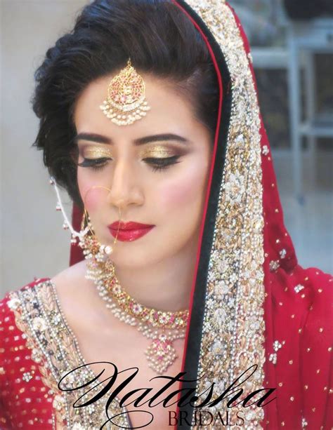 A Woman Wearing A Red And Gold Bridal Outfit