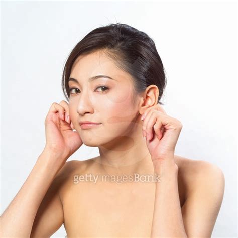Portrait Of A Young Woman Holding Her Earlobes 이미지 A7333370 게티이미지뱅크