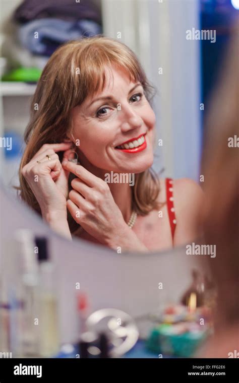 Mature Woman Applying Lipstick Stock Photo Alamy
