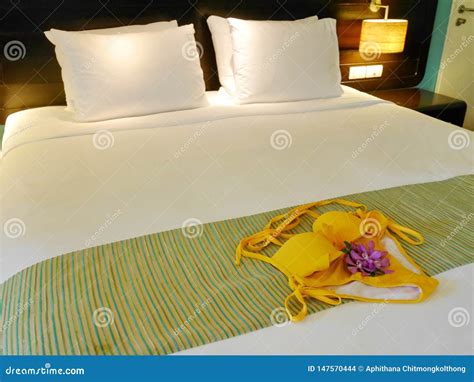 Top View Of Yellow Bikini With Purple Orchid On Abstract Fabric Copy Space Teenage Colorful