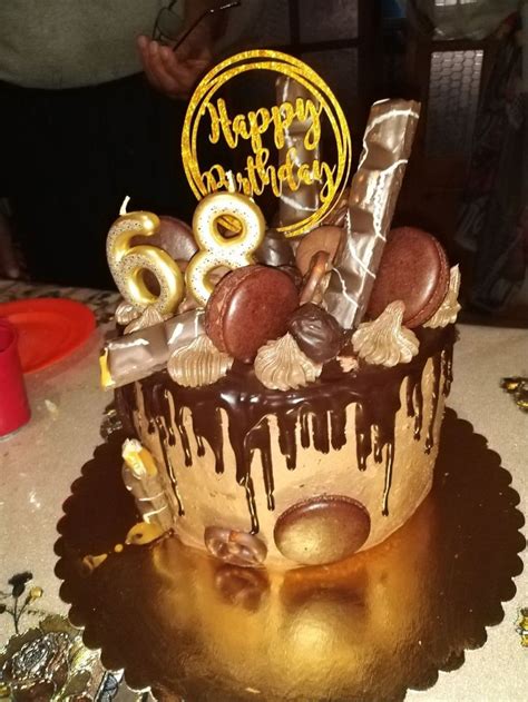 A Birthday Cake With Chocolate Icing And Decorations On It S Top Is