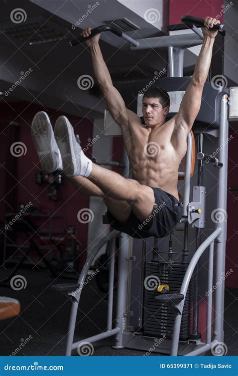 Man Using Pull Down Machine In Gymnasium.Handsome Muscular Man ...
