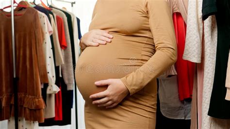 Closeup Of Pregnant Woman With Big Belly Caressing And Touching Her