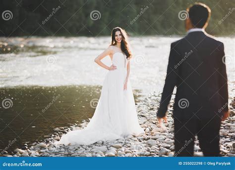 Elegant Stylish Happy Blonde Bride And Gorgeous Groom On The Background Of A Beautiful River In