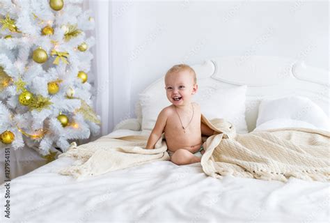 Cute Naked Baby Girl Sitting On Bed At Bedroom Christmas Stock Photo Adobe Stock