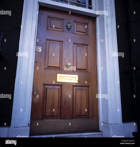 Traditional Paneled Wood Front Door With Brass Letter Box Stock Photo
