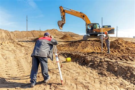 Premium Photo Surveying And Excavation Work At Construction Site