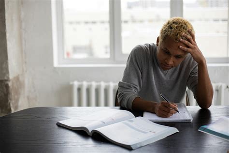 Wistful Black Man Writing In Notepad During Lesson · Free Stock Photo