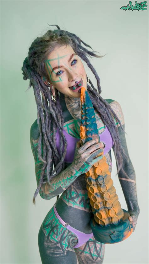 Heavily Tattooed Girl Anuskatzz Holds A Couple Of Taintacle Toys In The Nude CoedCherry