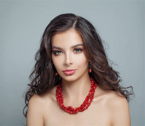 Perfect Brunette Model Woman With Makeup Long Curly Hair And Red Coral Necklace Stock Photo