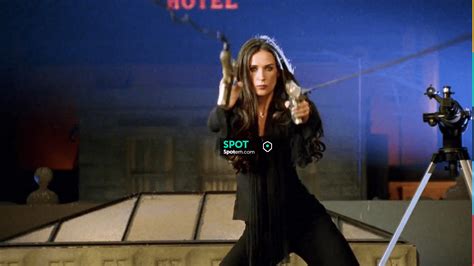 Black long sleeve top with attached scarf, black quilted sleeveless top