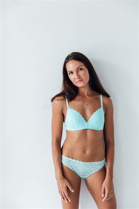 A Brunette Woman In Blue Lingerie Stands On A White Background Stock Image Image Of Fashion