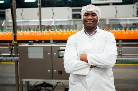 photo confident male worker standing  juice factory