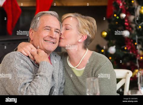 Mature Woman Kissing The Cheek Of Her Husband Stock Photo Alamy
