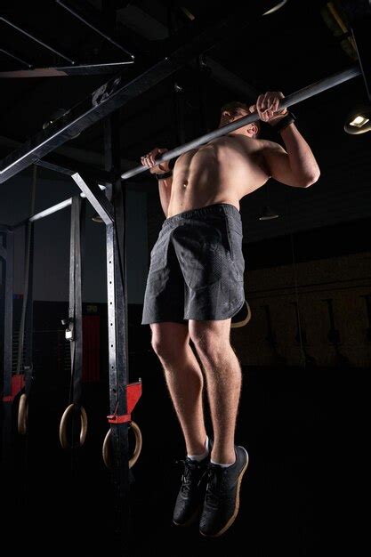 Premium Photo Full Body Of Unrecognizable Male Bodybuilder With Naked Torso Doing Pull Ups On