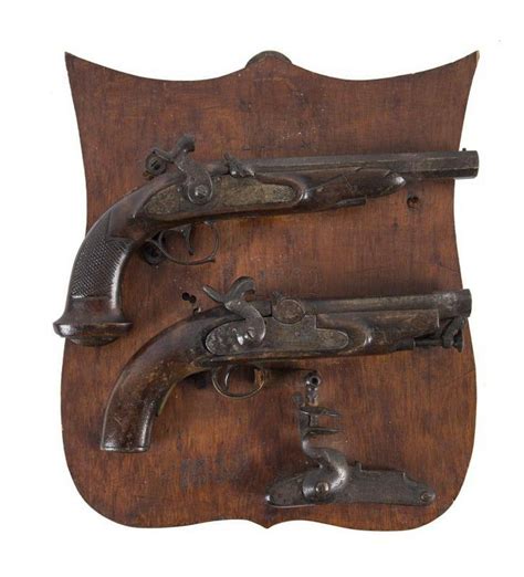 Antique Pistol Display With Flintlock And Percussion Caps Firearms