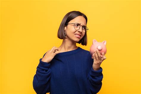 Joven latina sintiéndose estresada ansiosa cansada y frustrada tirando del cuello de la