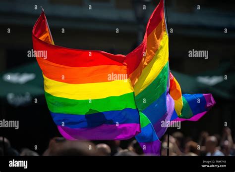 Rainbow Flag Supporting LGBT Community On Gay Parade Event Colourful Flag In The Crowd During