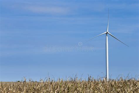 Single Wind Turbine In Green Field Against Dramatic Cloudy Sky France