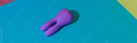 Violet Dildo Vibrator For Clitoris On Colored Background With Contrast Shadows Sex Toy For