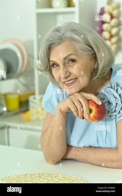 Mature Woman With Fresh Apple Stock Photo Alamy
