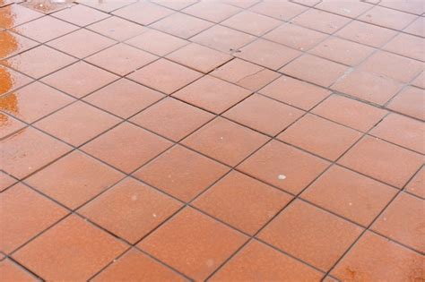 Premium Photo A Red Tile Floor With A Few Missing Tiles